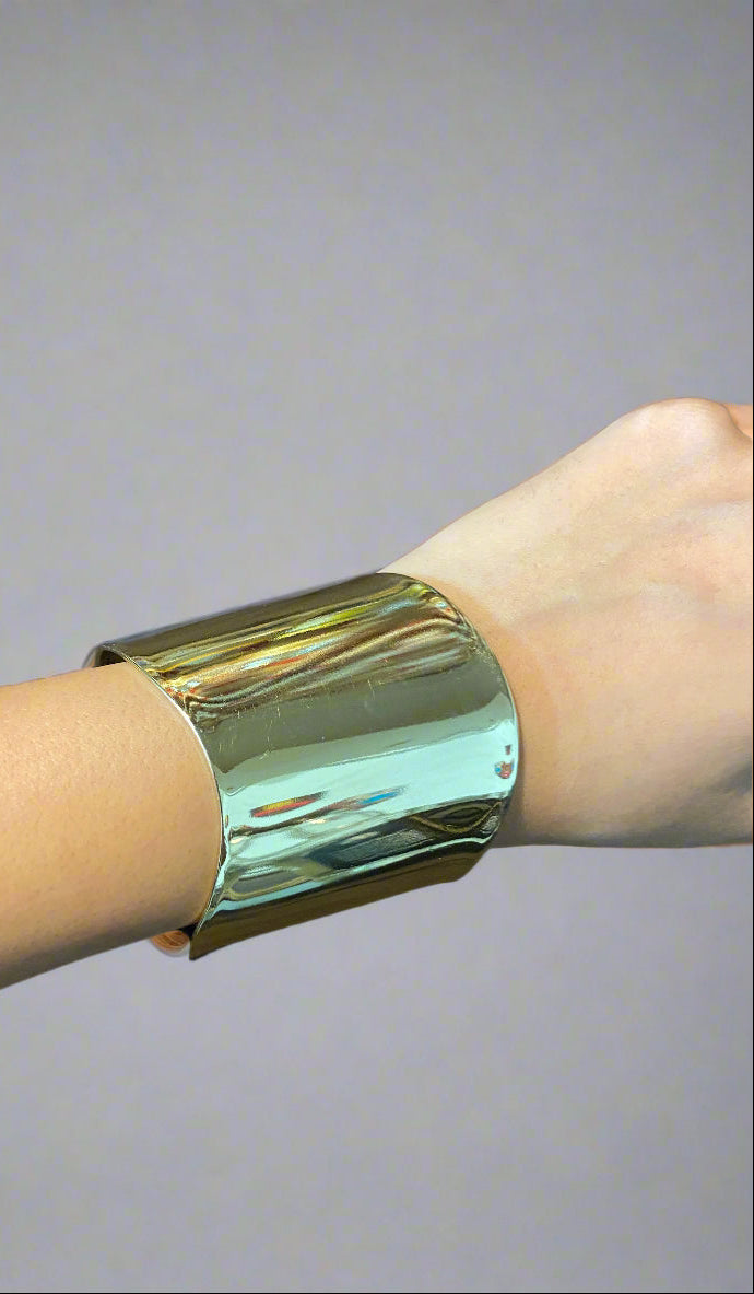 gold cuff bracelet on a hand