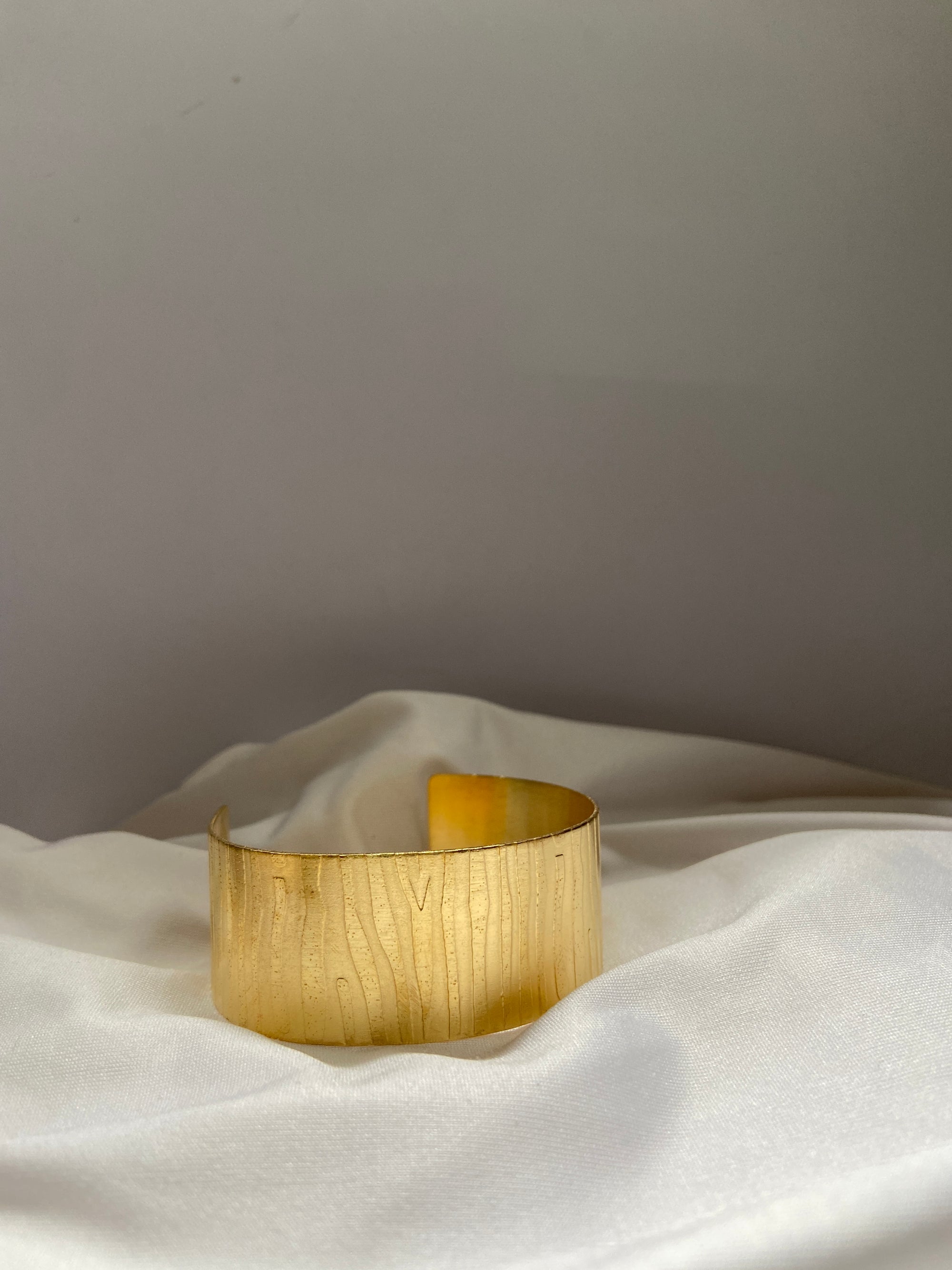 gold anti tarnish bracelet on a white fabric