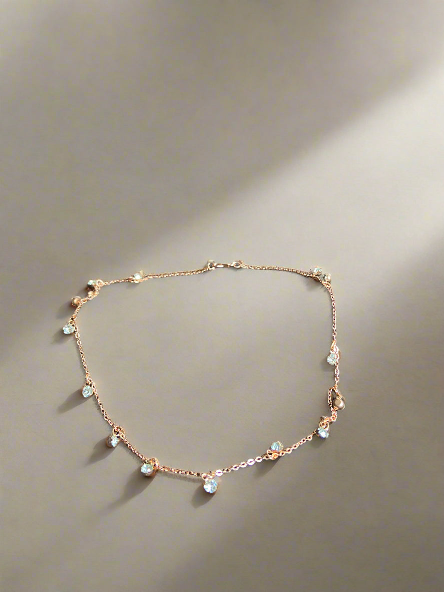 Necklace with small beads draped over a brown surface