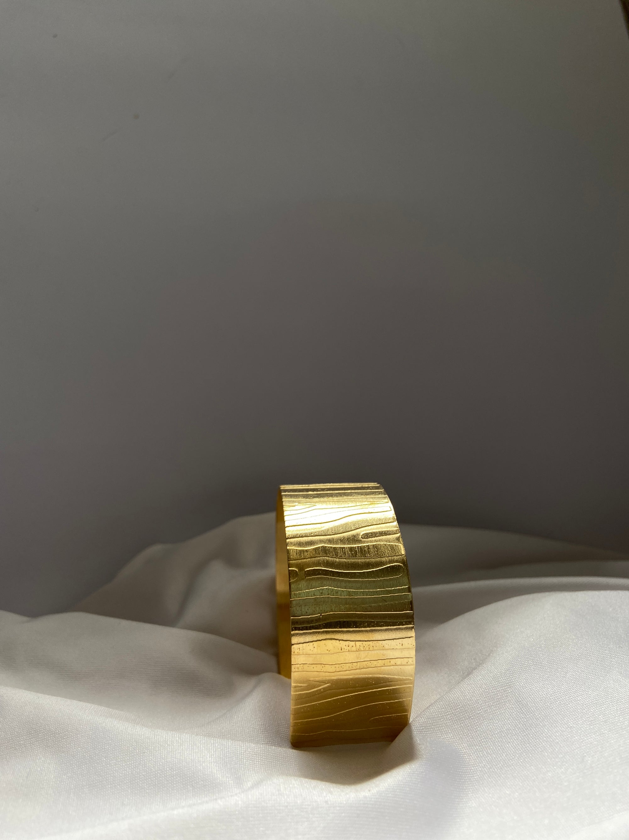 gold anti tarnish bracelet on a white fabric