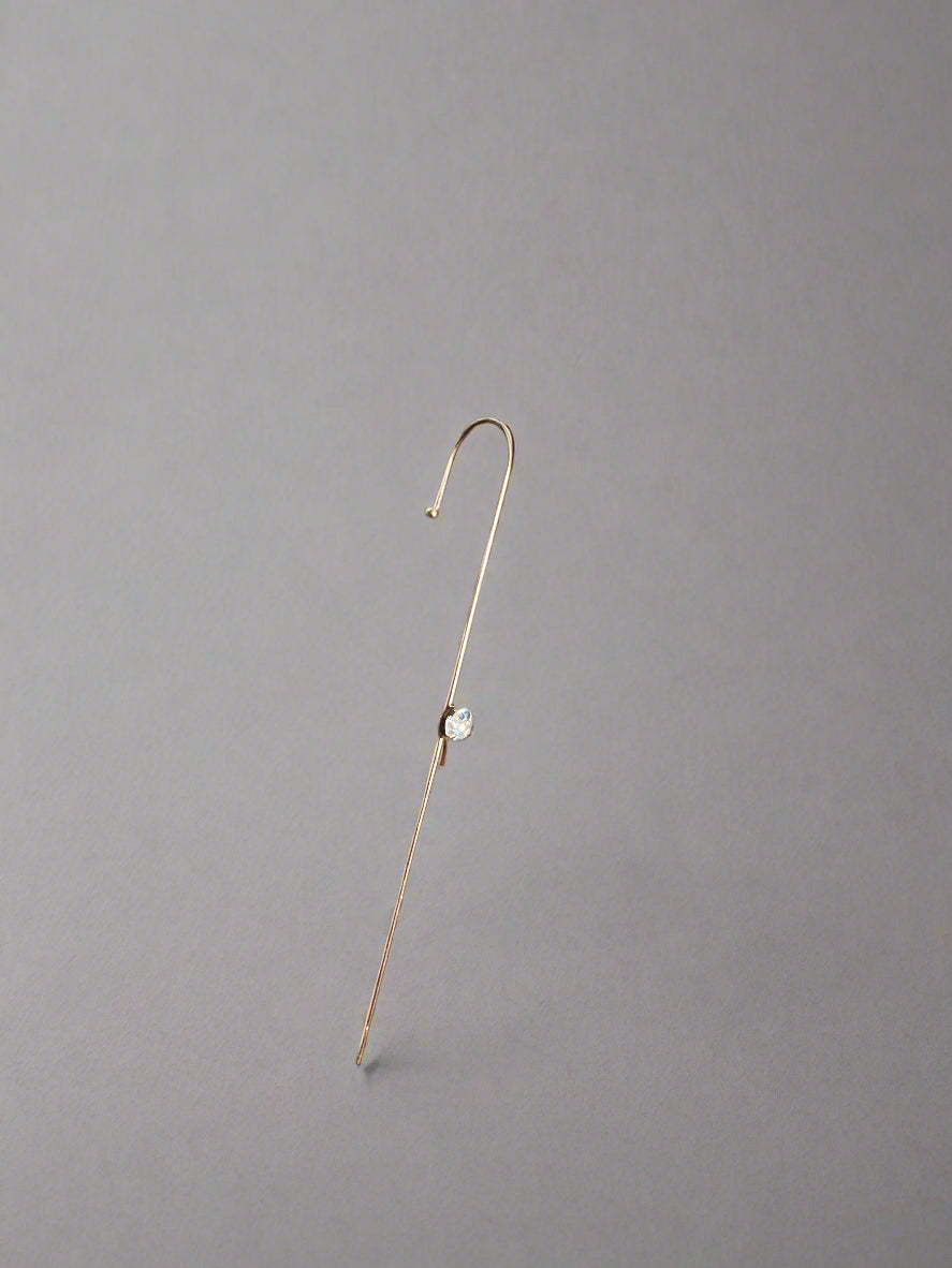 Gold ear cuff with a diamond
