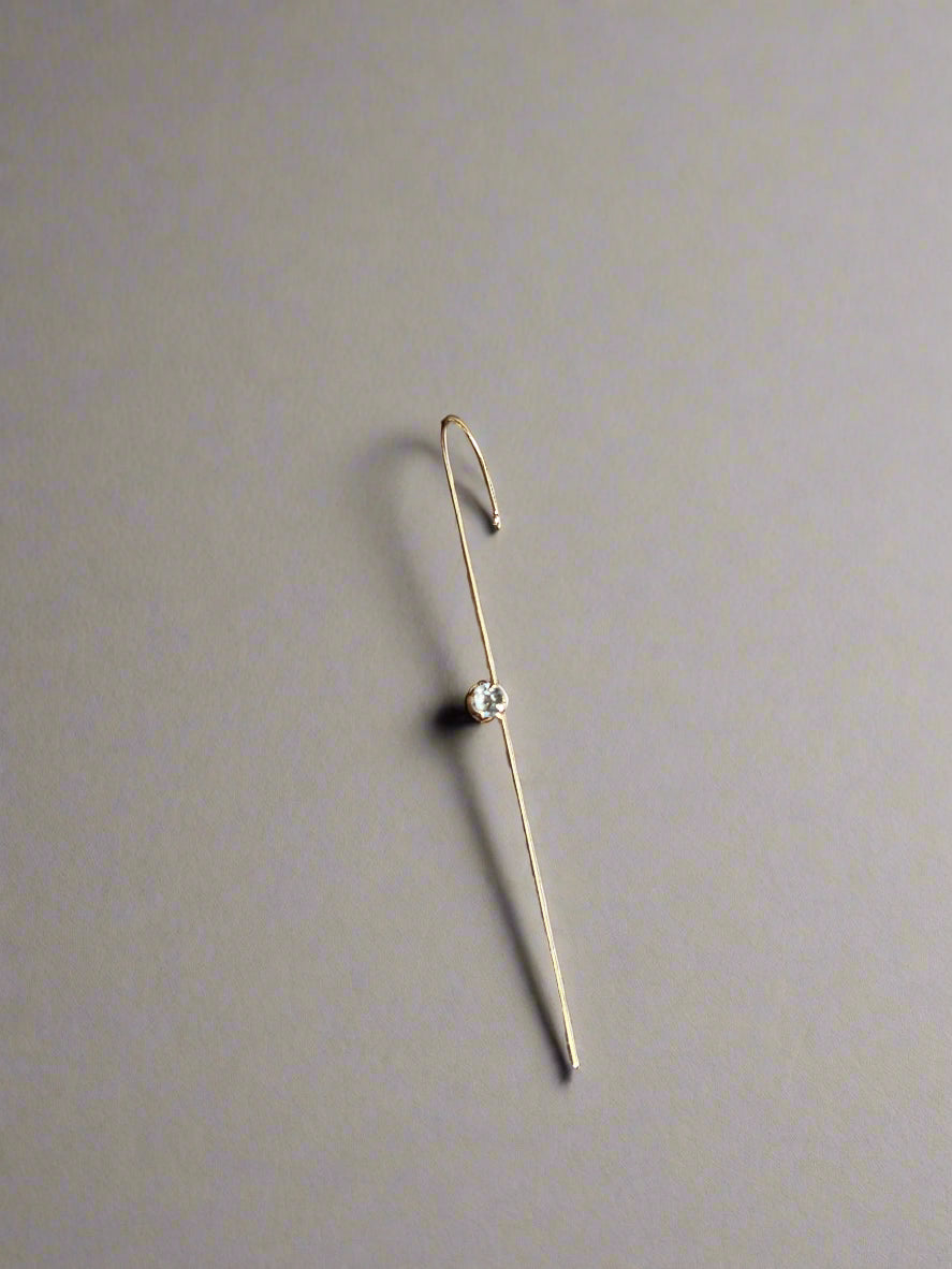 Gold ear cuff with a diamond