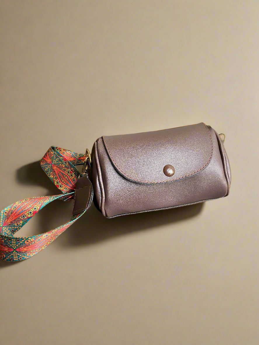 Brown leather pouch with a colorful strap 